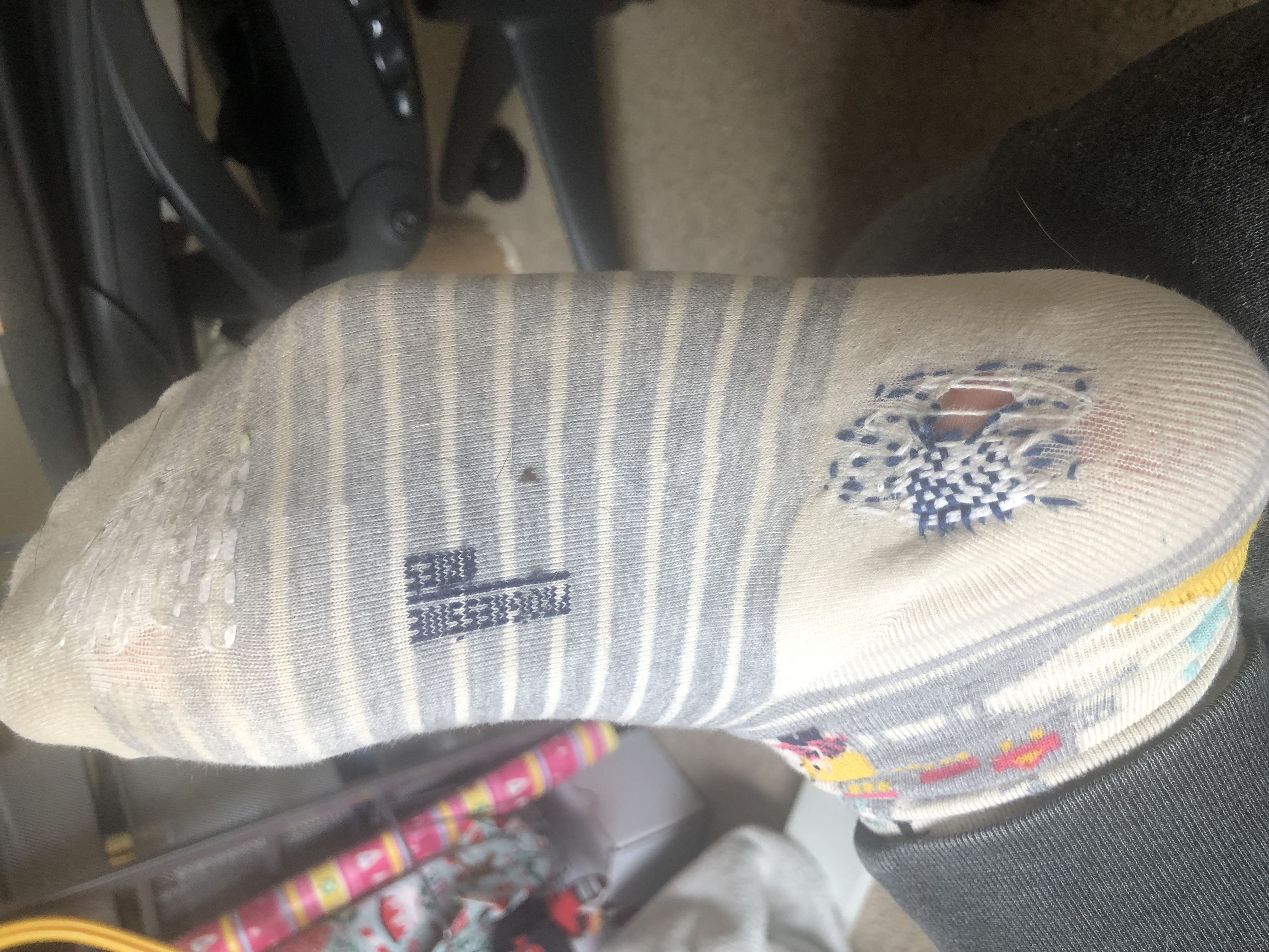 Mended socks with a hole using darning technique