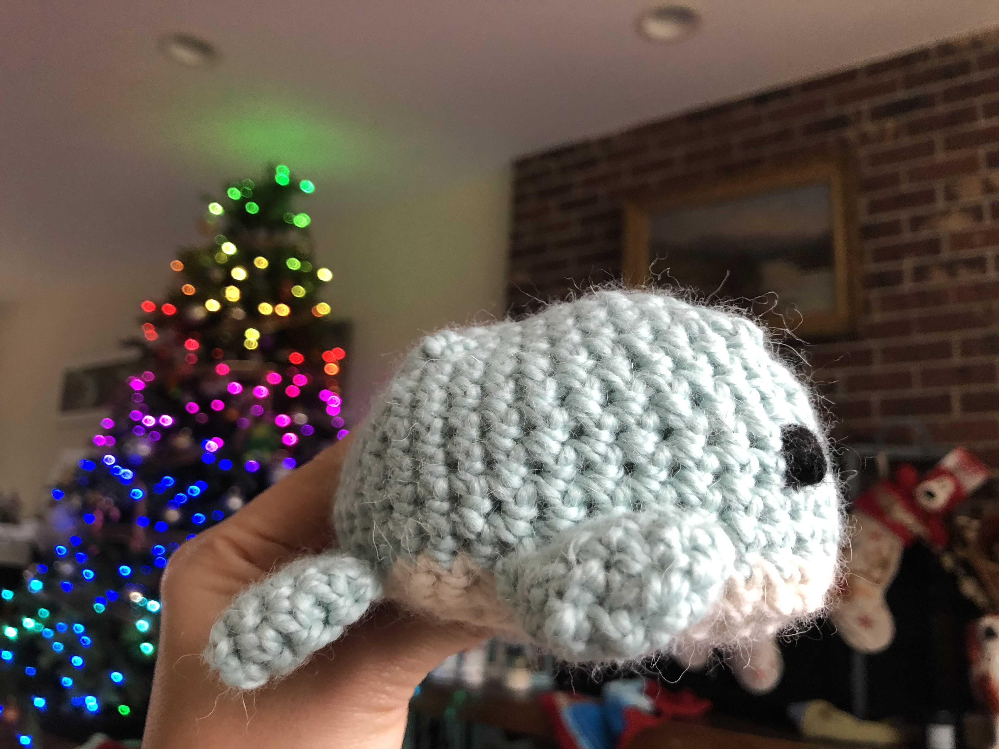 side view of blue and white crocheted amigurumi whale
