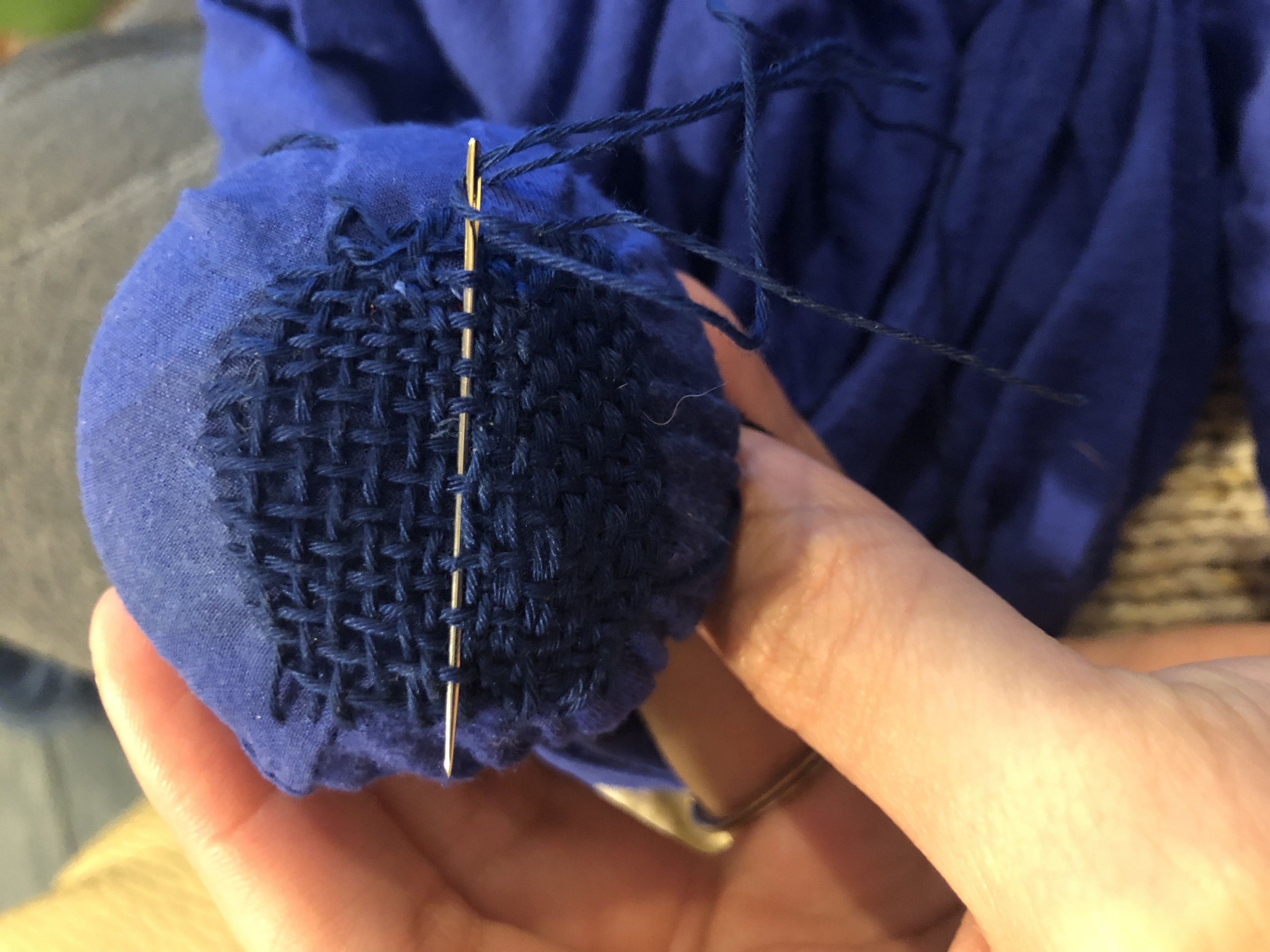 darning with blue thread