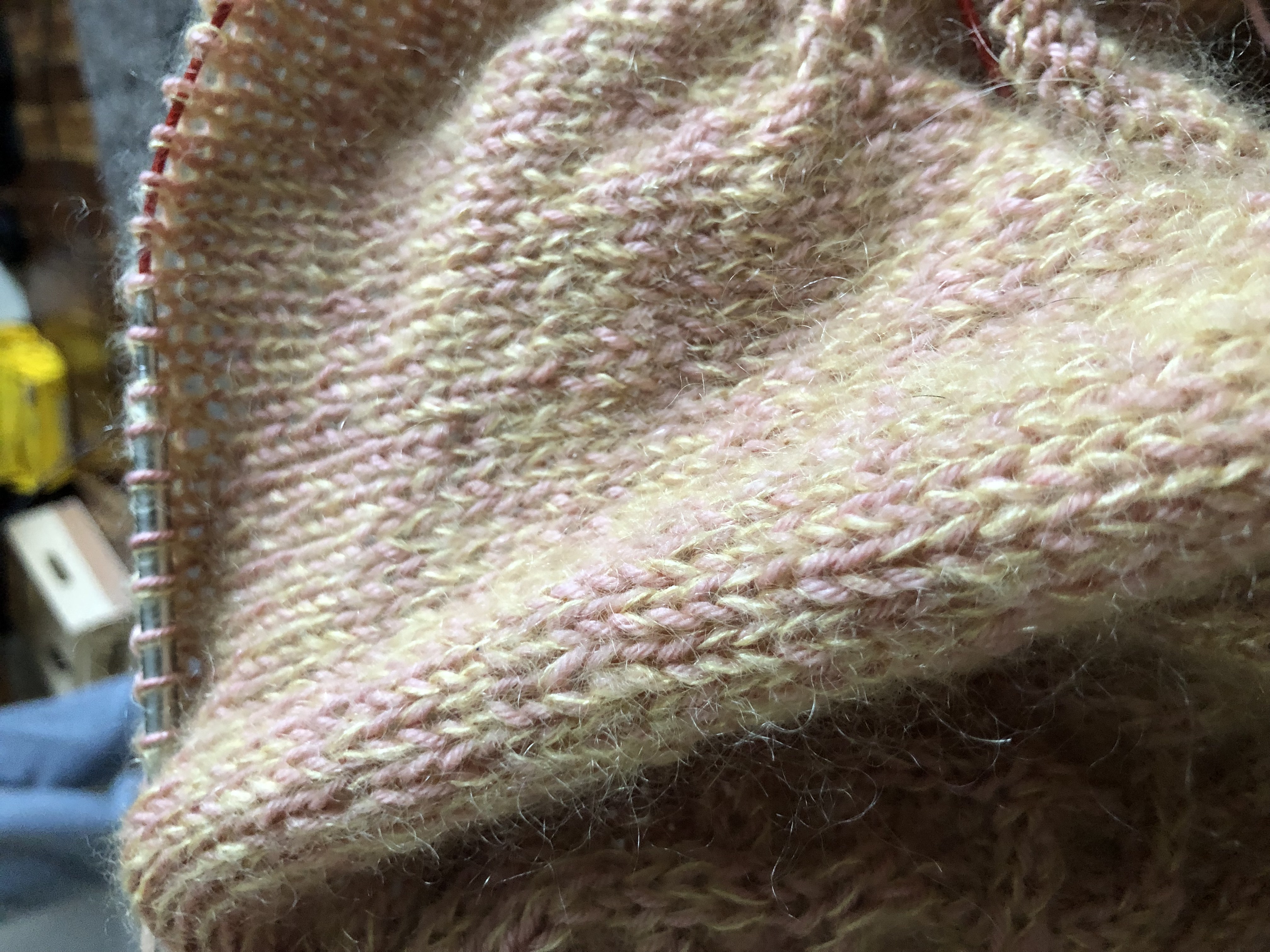 Close up photo of the knit with yellow mohair and pink wool fingering yarn.