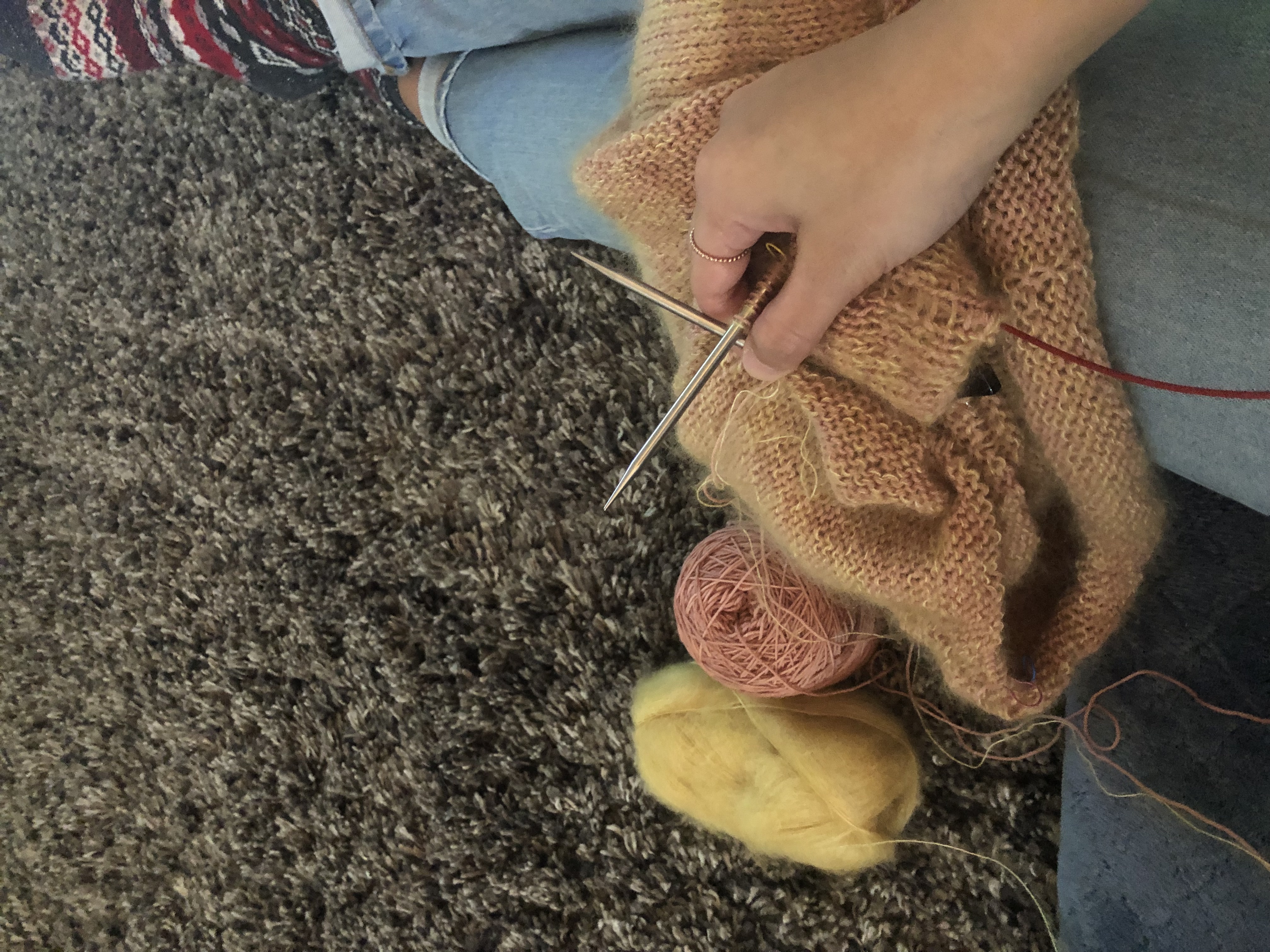 Work in progress sweater on needles with yellow mohair and pink wool fingering weight 